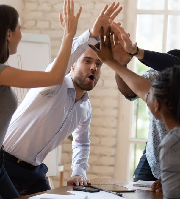 Overjoyed,Multiethnic,Millennial,Businesspeople,Give,High,Five,Celebrate,Shared,Business